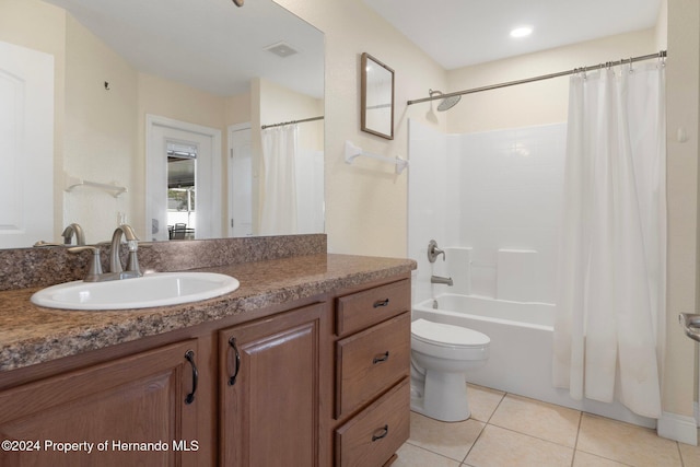 full bathroom with tile patterned flooring, shower / tub combo, vanity, and toilet