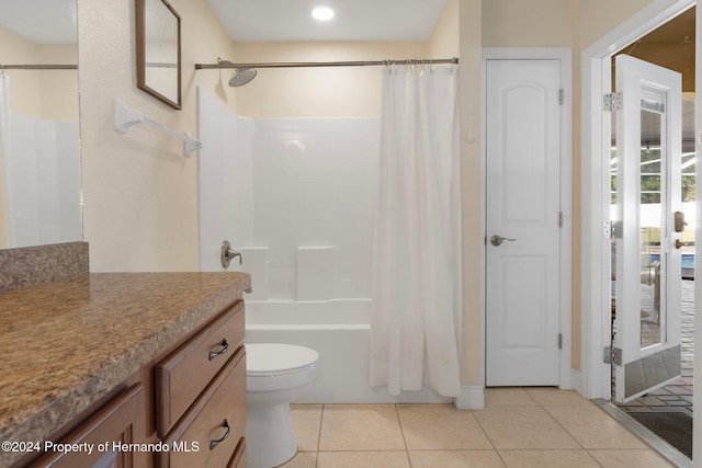 full bathroom featuring tile patterned flooring, shower / bath combo, vanity, and toilet