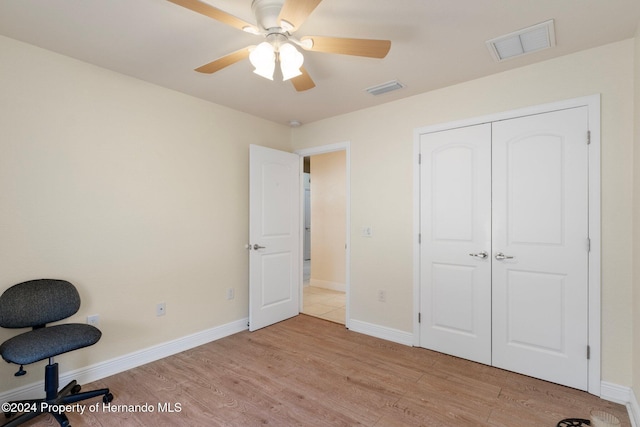 interior space with ceiling fan and light hardwood / wood-style floors