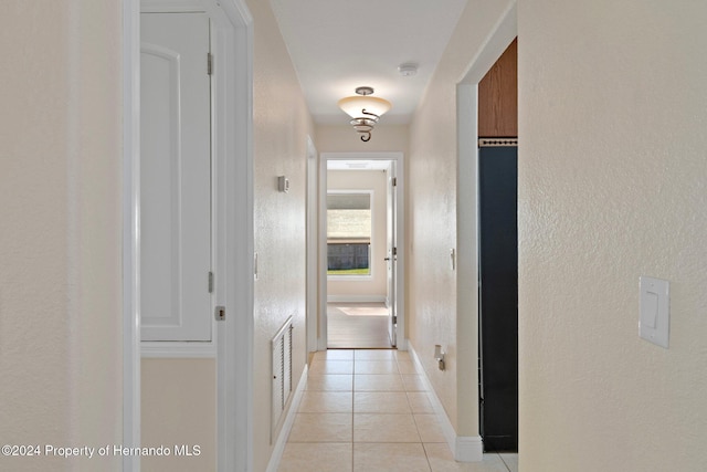 hallway featuring light tile patterned flooring