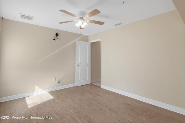 spare room with ceiling fan and light wood-type flooring