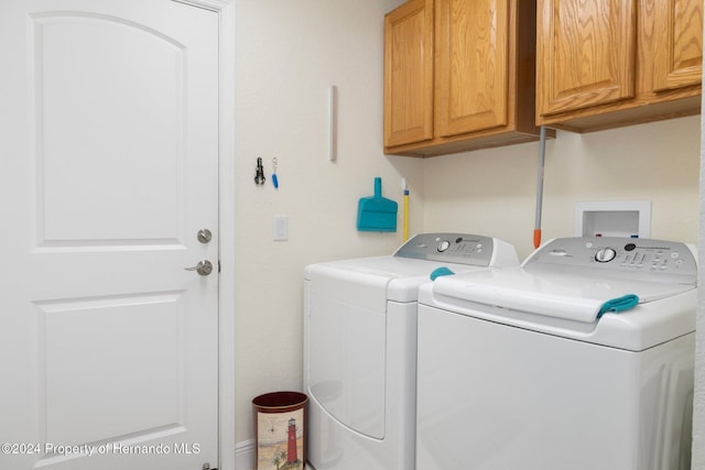 laundry area with cabinets and washer and dryer