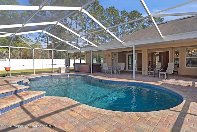 view of swimming pool with a lanai, ceiling fan, and a patio