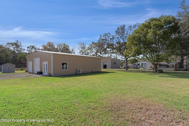 view of yard featuring an outbuilding and a garage