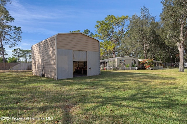 view of outbuilding featuring a yard