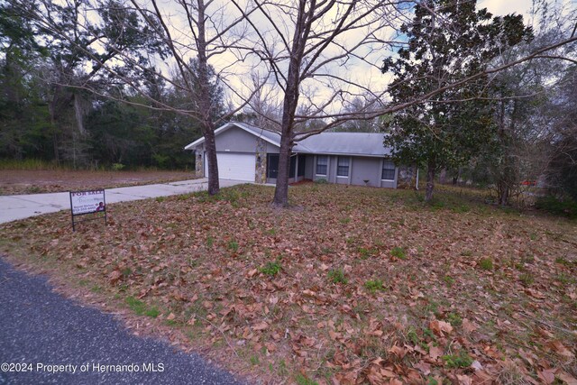 single story home featuring a garage