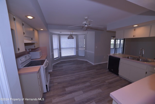 kitchen featuring white appliances, dark wood-type flooring, sink, white cabinetry, and hanging light fixtures