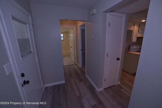 hallway with hardwood / wood-style floors