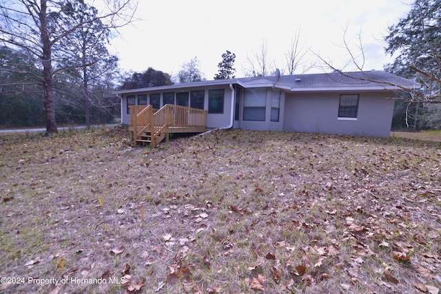 view of front of house featuring a deck and a sunroom