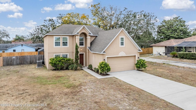 view of front of home featuring a garage and central AC