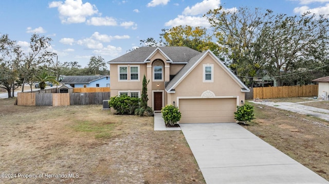 front of property featuring cooling unit and a garage