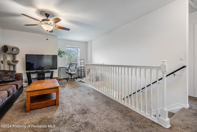 carpeted living room with ceiling fan