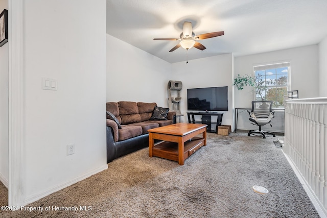 carpeted living room with ceiling fan