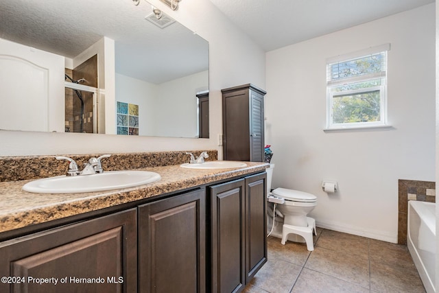 full bathroom featuring tile patterned floors, vanity, a textured ceiling, independent shower and bath, and toilet