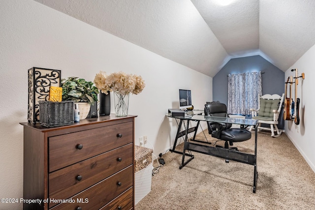 office area with lofted ceiling, light colored carpet, and a textured ceiling