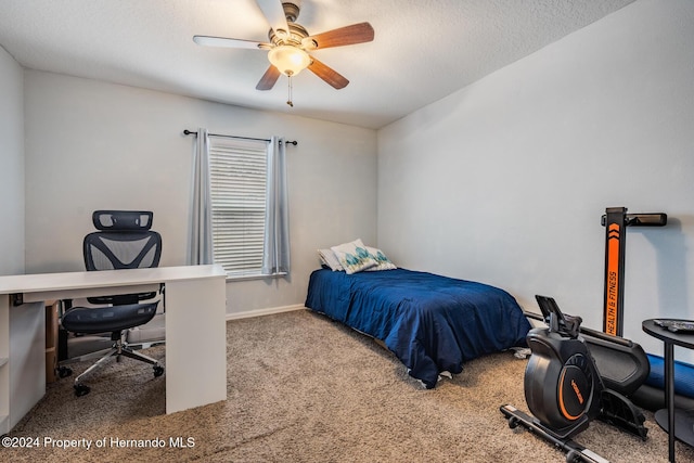 bedroom featuring a textured ceiling, carpet floors, and ceiling fan