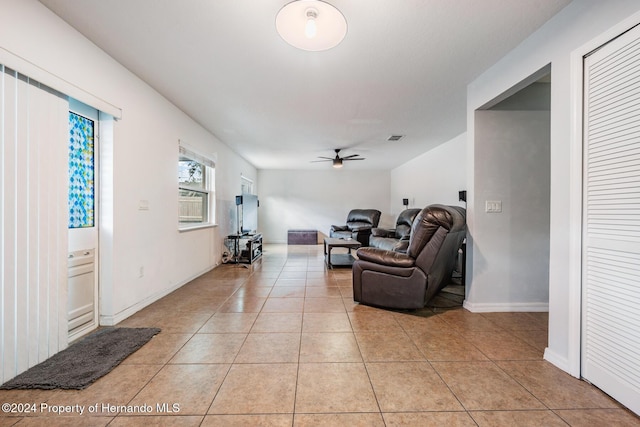 tiled living room featuring ceiling fan