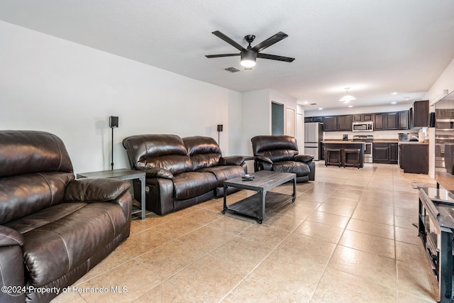 tiled living room featuring ceiling fan