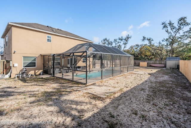 exterior space with a shed and glass enclosure