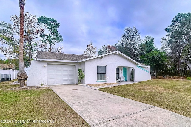 ranch-style house with a garage and a front lawn