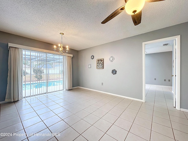 tiled spare room with a textured ceiling and ceiling fan with notable chandelier