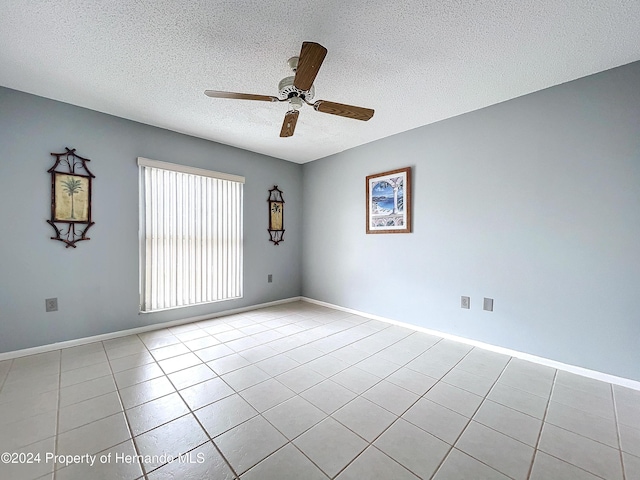 tiled empty room with a textured ceiling and ceiling fan