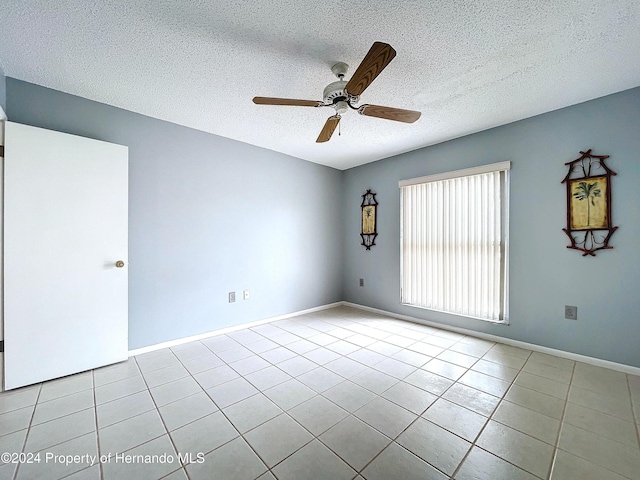 unfurnished room with light tile patterned floors, a textured ceiling, and ceiling fan