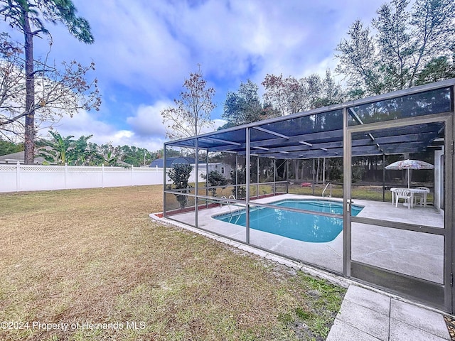 view of pool with a lanai, a yard, and a patio