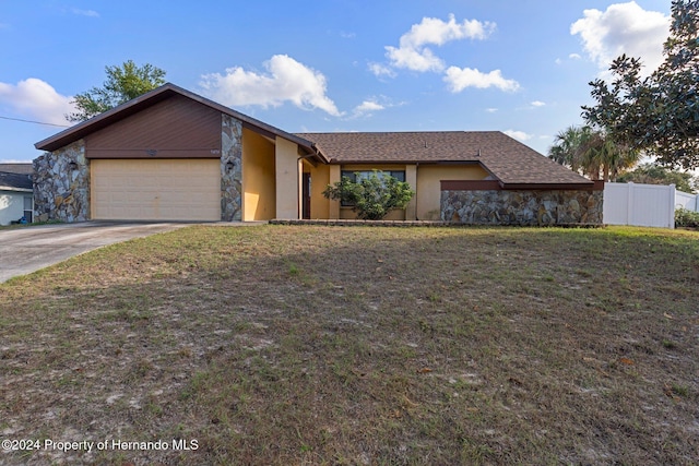 single story home with a front yard and a garage