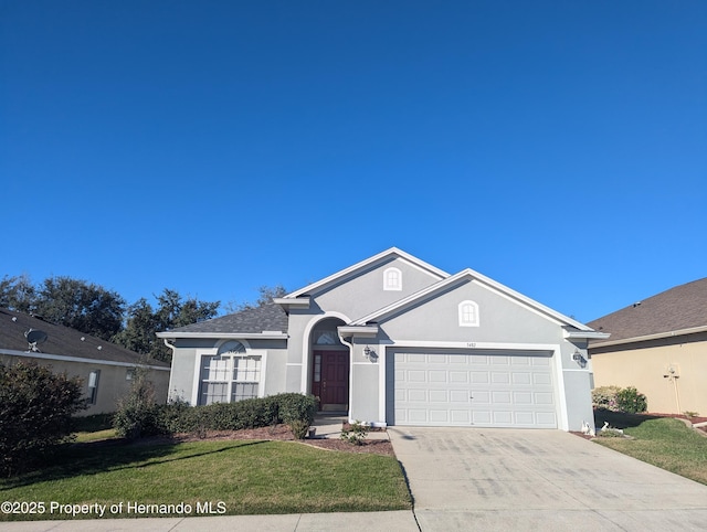 ranch-style home featuring a front lawn and a garage