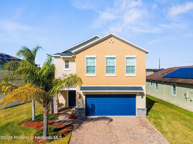 view of front facade featuring a front yard and a garage