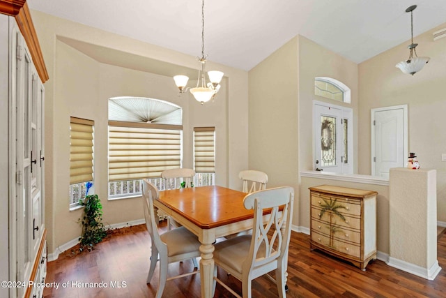 dining space featuring a notable chandelier, plenty of natural light, and dark hardwood / wood-style floors