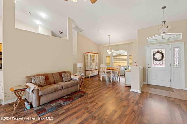 living room with ceiling fan, dark hardwood / wood-style floors, and lofted ceiling