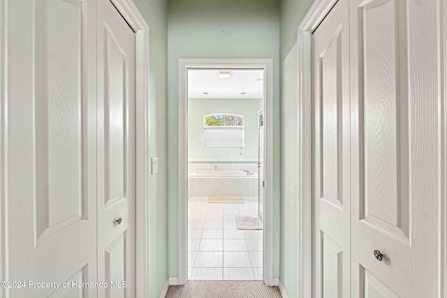 hallway featuring light tile patterned floors