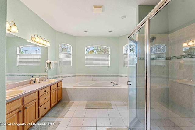 bathroom featuring tile patterned flooring, vanity, and independent shower and bath