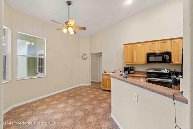 kitchen featuring a high ceiling, stainless steel electric range oven, and ceiling fan