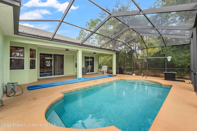 view of pool with a lanai, ceiling fan, and a patio