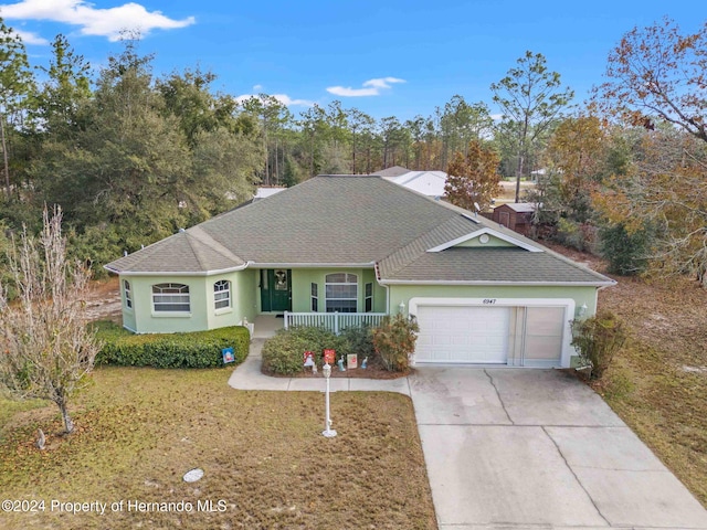 single story home featuring a porch and a garage