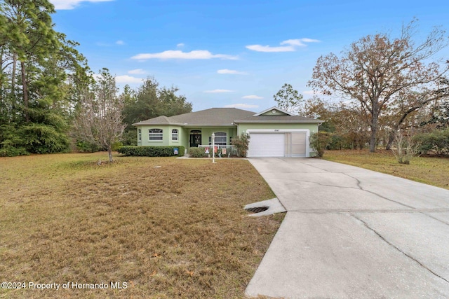 single story home with a garage and a front lawn