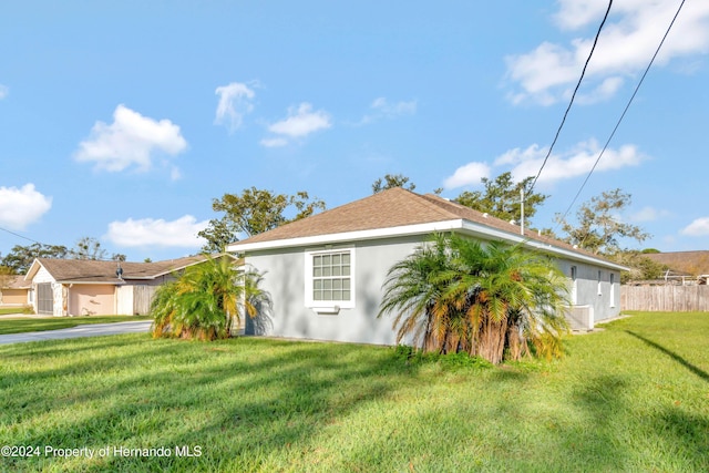 view of side of property with a lawn