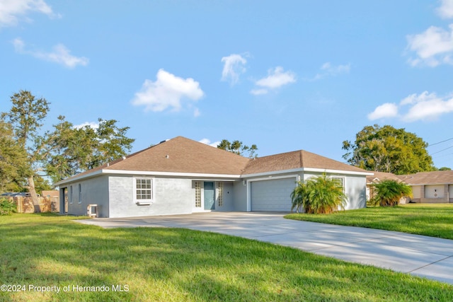 ranch-style house featuring a garage and a front yard