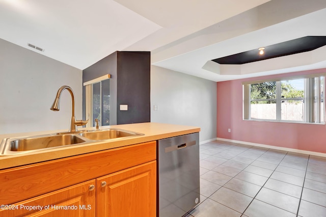 kitchen with stainless steel dishwasher, light tile patterned floors, and sink