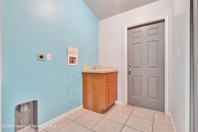 laundry room featuring sink, cabinets, electric dryer hookup, hookup for a washing machine, and light tile patterned flooring