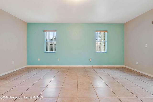 tiled empty room with a healthy amount of sunlight