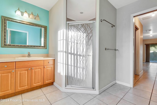 bathroom featuring vanity, tile patterned floors, and a shower with door