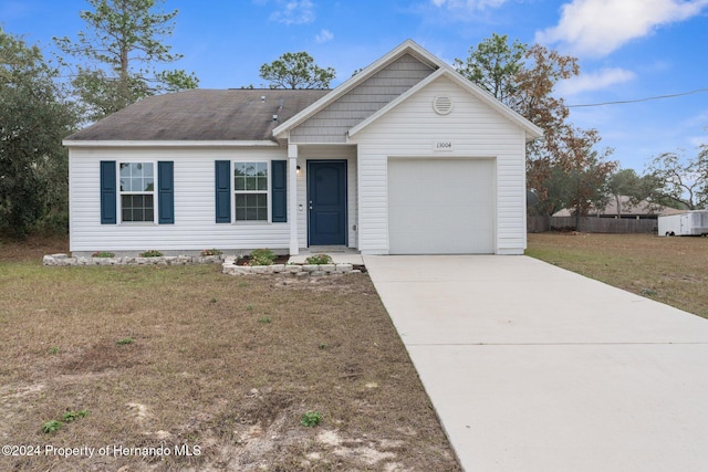 view of front of house with a garage and a front yard