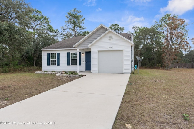 view of front of house with a front yard and a garage