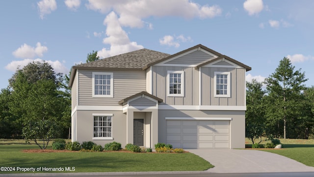 view of front of home with a front yard and a garage