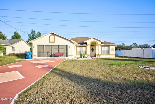 single story home featuring a front lawn