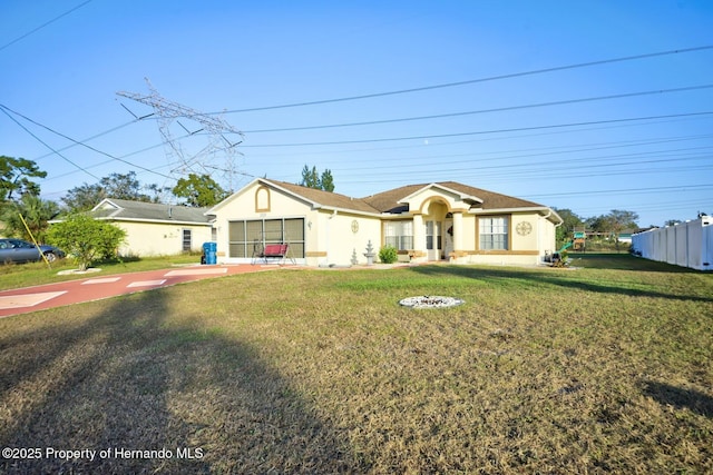 ranch-style home with a front lawn